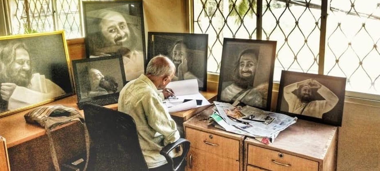 Daya in his studio surrounded by paintings of Sri Sri Ravishankar